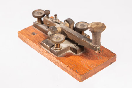 Telegraph key or Morse key isolated on white background. Vintage Morse code telegraphy device side view.の写真素材