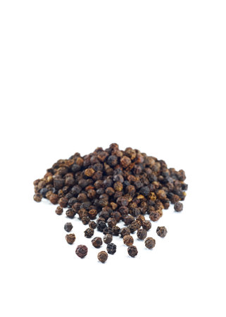Black pepper corns over the white background, set of several imagesの写真素材