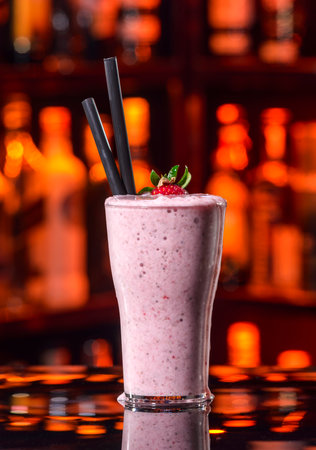 strawberry milkshake in a glass on a bar backgroundの写真素材