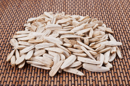 Sunflower seeds on a bamboo mat. close up Whole background.の写真素材