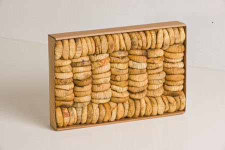 Crispy round cookies in a wooden box on a white backgroundの写真素材