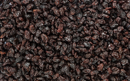 Black raisins as a background. Close-up image.の写真素材