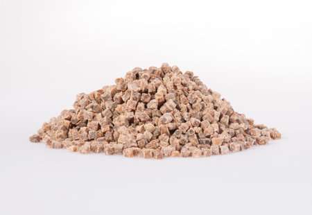 Pile of brown cane sugar on a white background. isolatedの写真素材
