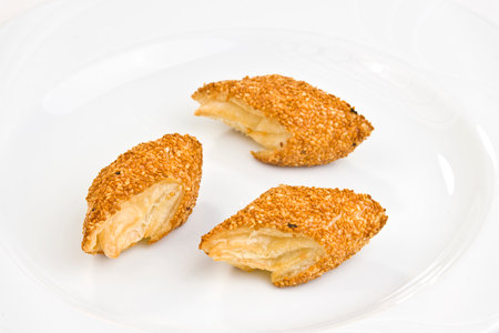 pie with sesame seeds on a white background in the restaurantの写真素材