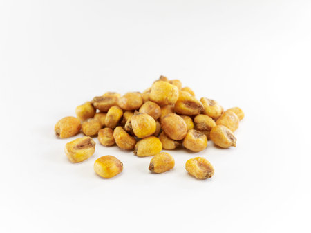close up of dried corns on white background, healthy food concept