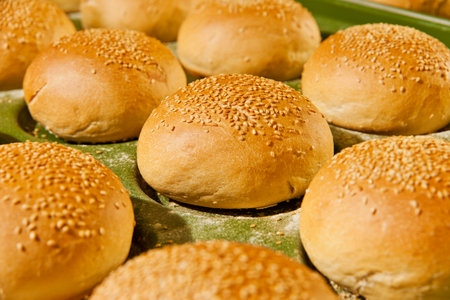 Bread buns with sesame seeds on a baking sheet.の写真素材