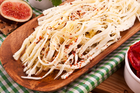 Fettuccine cake with fresh figs on a wooden boardの写真素材