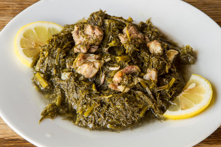 Traditional swedish dish of green kale with pork on wooden tableの写真素材