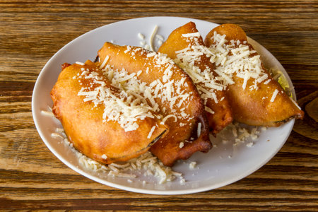 Fried prawns with cheese in white plate on wooden tableの写真素材