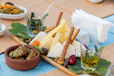 Cheese platter with olives, sunflower seeds and herbsの写真素材