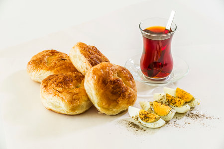 Bread buns with tea and egg on a white background.の写真素材