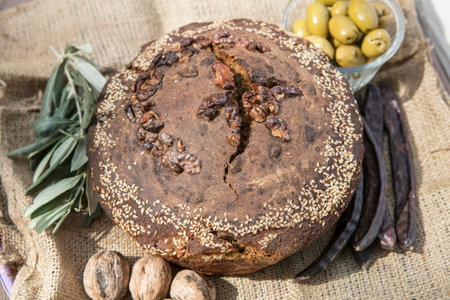 Bread with olives and raisins on sackcloth backgroundの写真素材