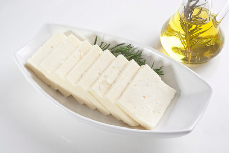Slices of feta cheese on a plate with olive oil