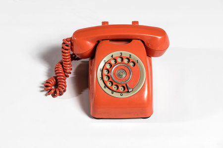 Old red telephone isolated on a white background with copy space for textの写真素材