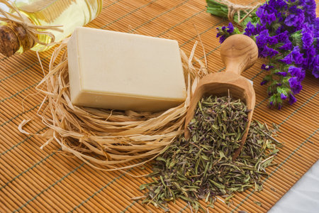 Spa still life with herbal soap and essential oil on bamboo matの写真素材