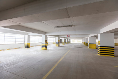 Parking garage interior with yellow and black stripes, nobody inside.の写真素材