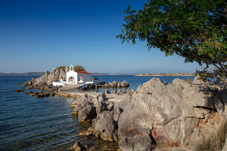 Little church of Agios Isidoros in the sea over the rocks, Chios island, Greece.