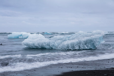 Big pieces of ice (floe) from glacier in the lake, ice islands, glacier and mountains, JÃ¶kulsÃ¡rlÃ³n - Glacier Lagoonの写真素材