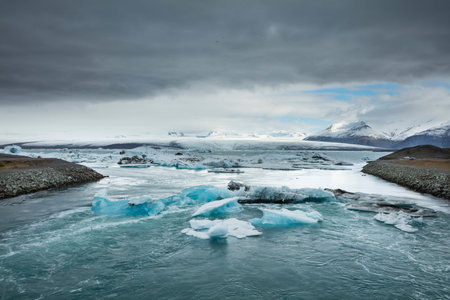 Big pieces of ice (floe) from glacier in the lake, ice islands, glacier and mountains,...