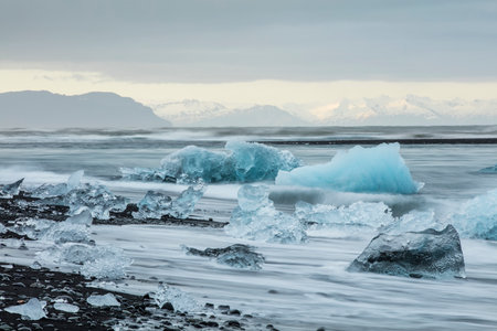 Big pieces of ice (floe) from glacier in the lake, ice islands, glacier and mountains, JÃ¶kulsÃ¡rlÃ³n - Glacier Lagoonの写真素材