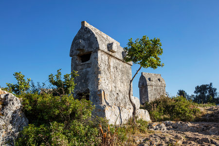 View of ancient Lycian town Simena with fortress on a mount on the coast of the Mediterranean sea in Antalya Province, Turkeyの写真素材