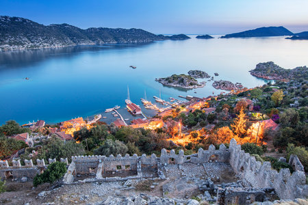 View of ancient Lycian town Simena with fortress on a mount on the coast of the Mediterranean sea in Antalya Province, Turkeyの写真素材