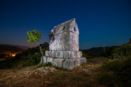 View of ancient Lycian town Simena with fortress on a mount on the coast of the Mediterranean sea in Antalya Province, Turkeyの写真素材