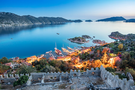 View of ancient Lycian town Simena with fortress on a mount on the coast of the Mediterranean sea in Antalya Province, Turkeyの写真素材