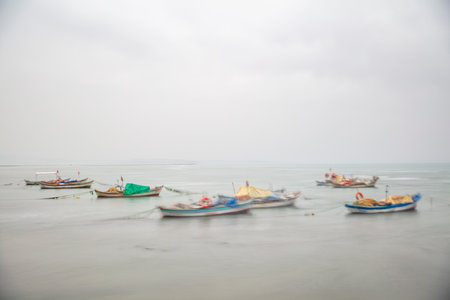 Fishing boats on the beach in a foggy day, Sri Lankaの写真素材