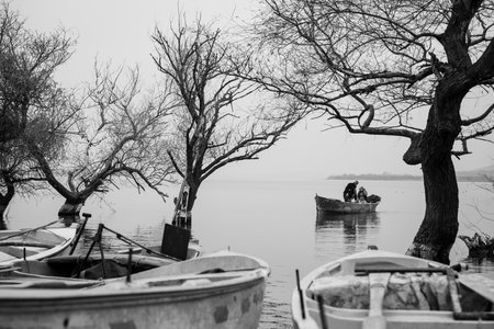 Fishing boats on the lake, Black and white photo with selective focusの写真素材