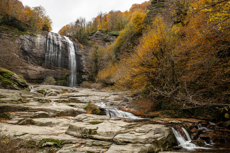 Autumn landscape with waterfall and colorful forest in Caucasus mountains, Georgiaの写真素材