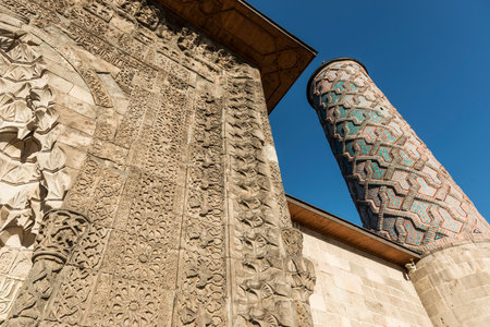 Yakutiye Medresse Erzurum Turkey This structure was built by Cemaleddin Hodja Yakut on behalf of Gazan Han and Bolugan Hatun in 1310 during the Inhansid emperor perod. Puï¿½l rooms and classrooms are located on either side of court. The surface of the room entrances have rosettas including different geomatrical and botanical decorations. The panels that consist of eagle, tree of life and lion motifs are located at both sides of the portal. There is a brick decoration on the minaret body in the south-west corner. The tomb is next to the uï¿½er hall in the east. Today the Medresse in used is Turkish and Islamic works and Ethnographic museum where various ethnographical objects of the region are exhibited.の写真素材