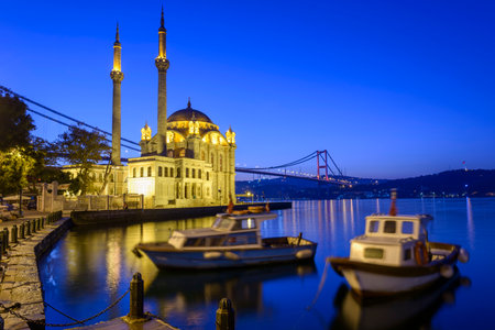 Colorful Ortakoy mosque and Bosphorus Bridge reflection on the seaの写真素材