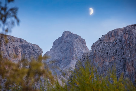 Moon in the sky over the mountains in Sierra Nevada, California, USAの写真素材