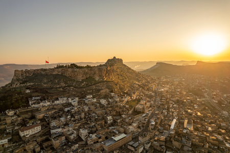 Traditional pink stone houses of Mardin Old town Mesopotamia in the background- Mardin, Turkeyの写真素材
