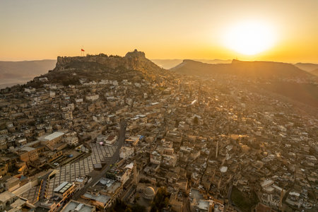 Traditional pink stone houses of Mardin Old town Mesopotamia in the background- Mardin, Turkeyの写真素材