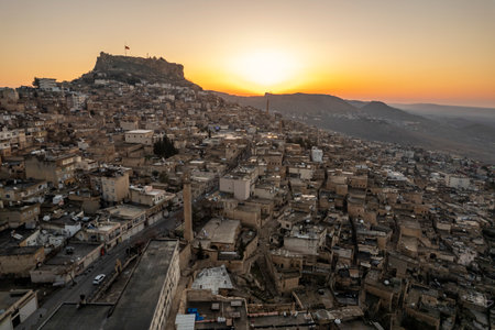 Traditional pink stone houses of Mardin Old town Mesopotamia in the background- Mardin, Turkeyの写真素材