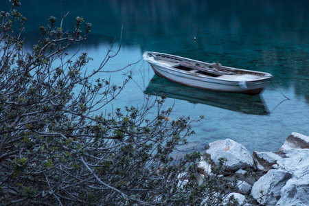 Boat on the shore of the turquoise lake in Croatiaの写真素材