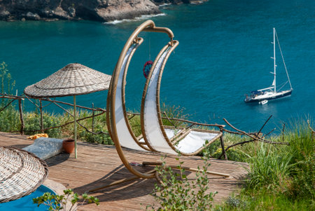 Wooden deck chair on the beach in Santorini, Greeceの写真素材