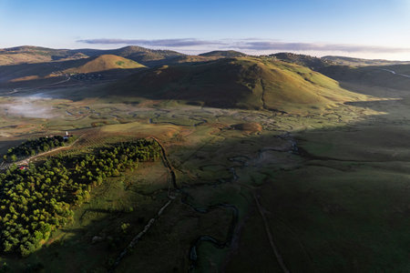 Aerial drone panorama landscape photo of Persembe Plateau (aka PerÅembe Yaylasi), creek meander (aka meander) and sheep on grassland, Aybasti, Ordu, Black Sea Region of Turkeyの写真素材