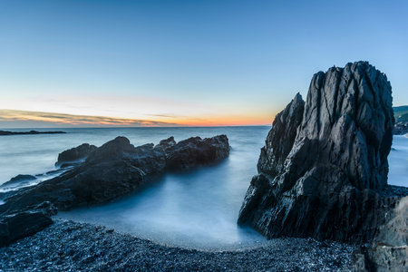 Long exposure of a rocky beach at sunset. Long exposure image.