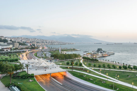 Konak Square street view with old clock tower at sunset. It was built in 1901 and accepted as the official symbol of Izmir City, Turkey.の写真素材