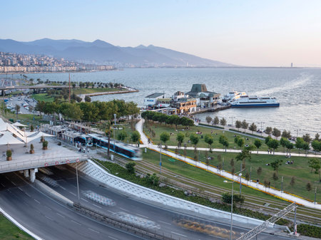 Konak Square street view with old clock tower at sunset. It was built in 1901 and accepted as the official symbol of Izmir City, Turkey.の写真素材