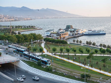 Konak Square street view with old clock tower at sunset. It was built in 1901 and accepted as the official symbol of Izmir City, Turkey.の写真素材