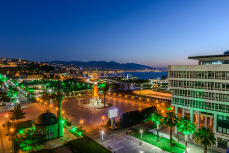Konak Square street view with old clock tower (Clock Tower) at sunset. It was built in 1901 and accepted as the official symbol of Izmir City, Turkey.の写真素材