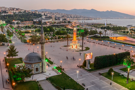 Konak Square street view with old clock tower (Clock Tower) at sunset. It was built in 1901 and accepted as the official symbol of Izmir City, Turkey.の写真素材