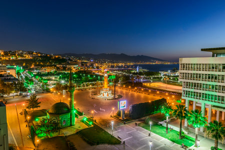 Konak Square street view with old clock tower (Clock Tower) at sunset. It was built in 1901 and accepted as the official symbol of Izmir City, Turkey.の写真素材