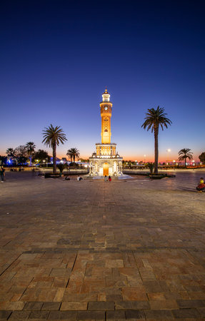 Konak Square street view with old clock tower (Clock Tower) at sunset. It was built in 1901 and accepted as the official symbol of Izmir City, Turkey.の写真素材