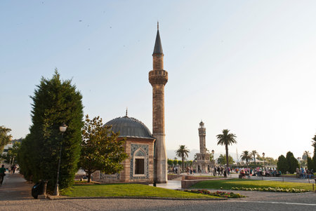 Konak Square street view with old clock tower (Clock Tower) at sunset. It was built in 1901 and...