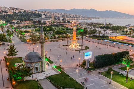 Konak Square street view with old clock tower (Clock Tower) at sunset. It was built in 1901 and accepted as the official symbol of Izmir City, Turkey.の写真素材